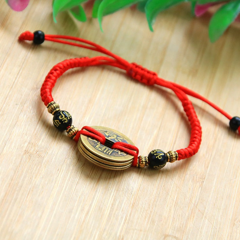 Bracelet pour attirer l'abondance en corde rouge tissé à la main avec des pièces de cuivre