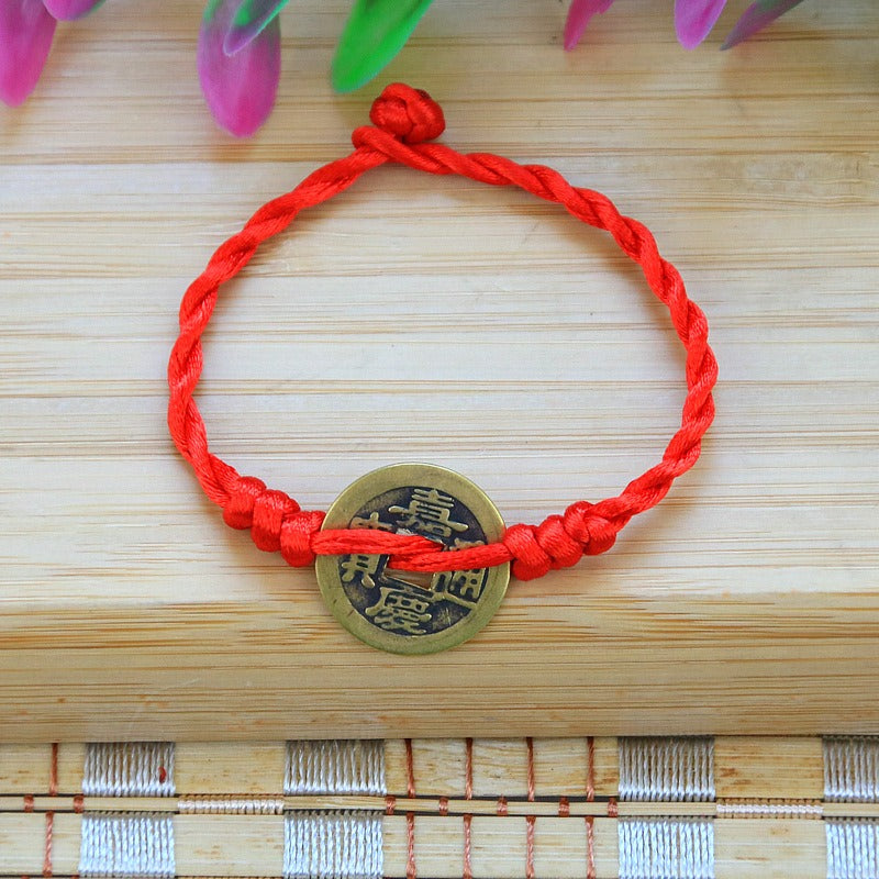 Bracelet to attract abundance in red rope hand-woven with copper coins