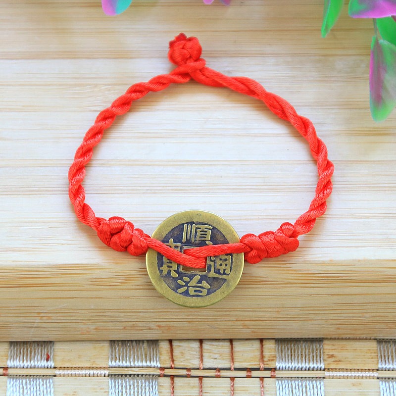 Bracelet to attract abundance in red rope hand-woven with copper coins